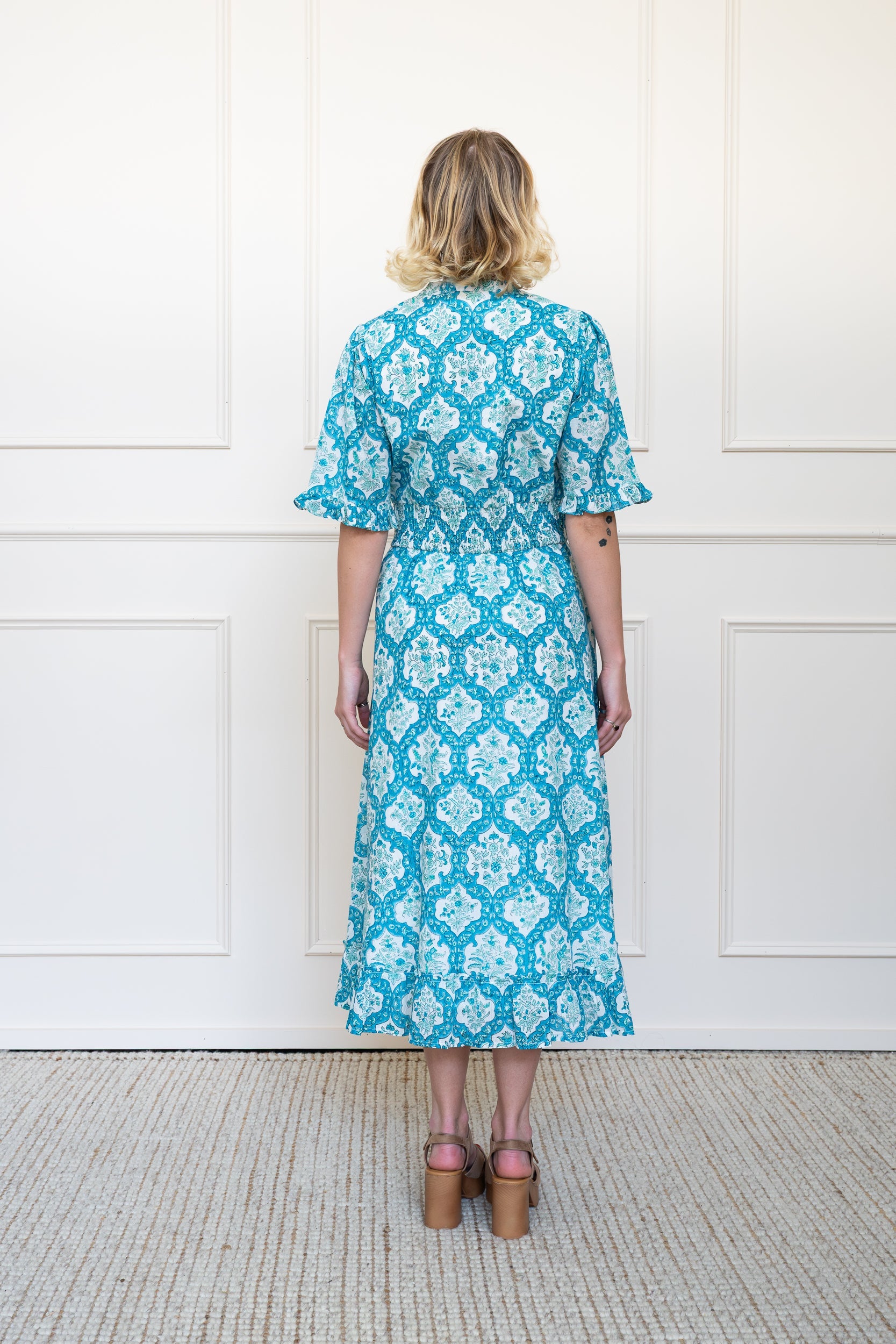 Back view of Airlie Dress in Ocean Corals showing flattering A-line silhouette and breathable organic cotton fabric.