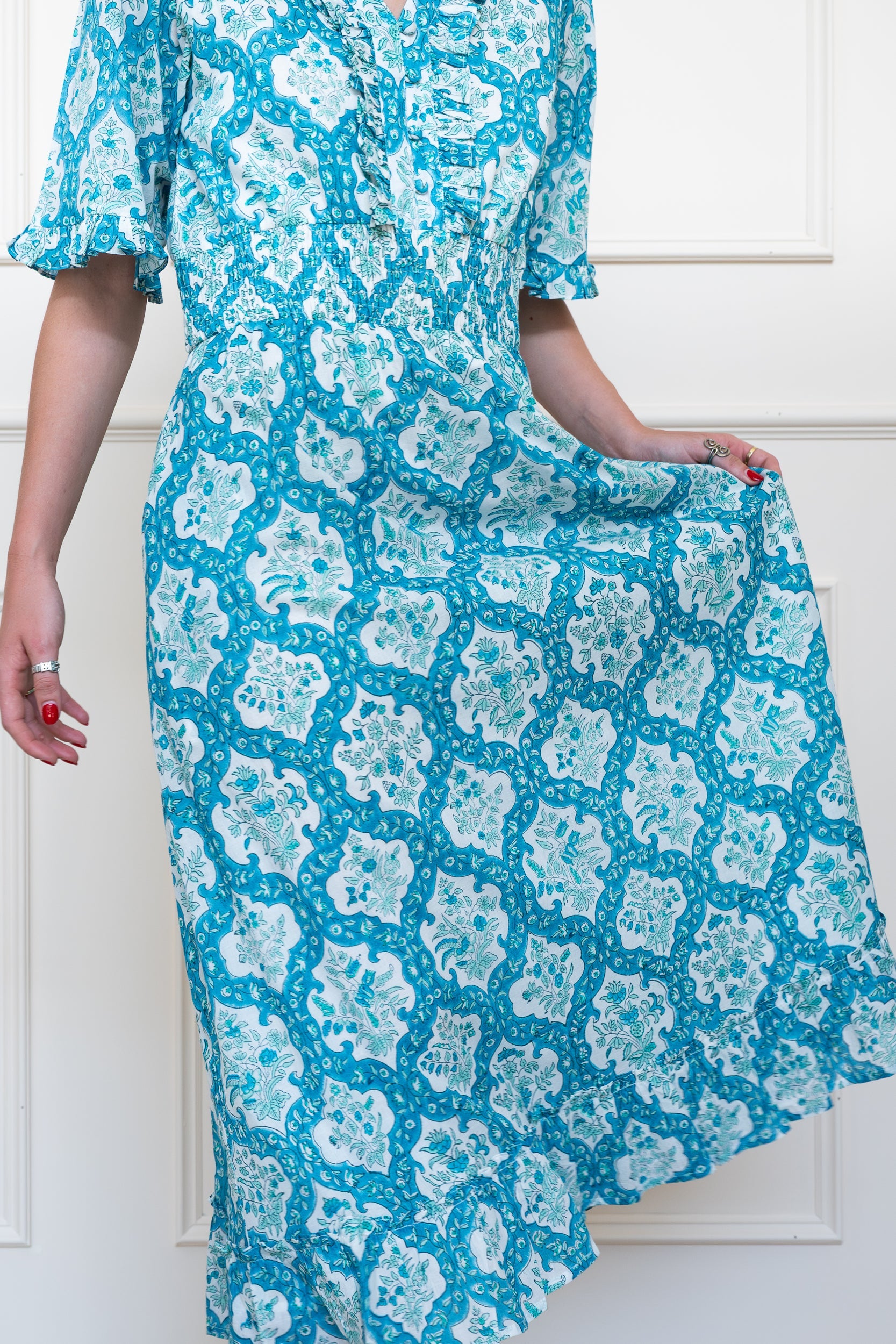 Airlie Dress in Ocean Corals Blue showing flowing midi skirt suitable for summer wedding guest or day events.