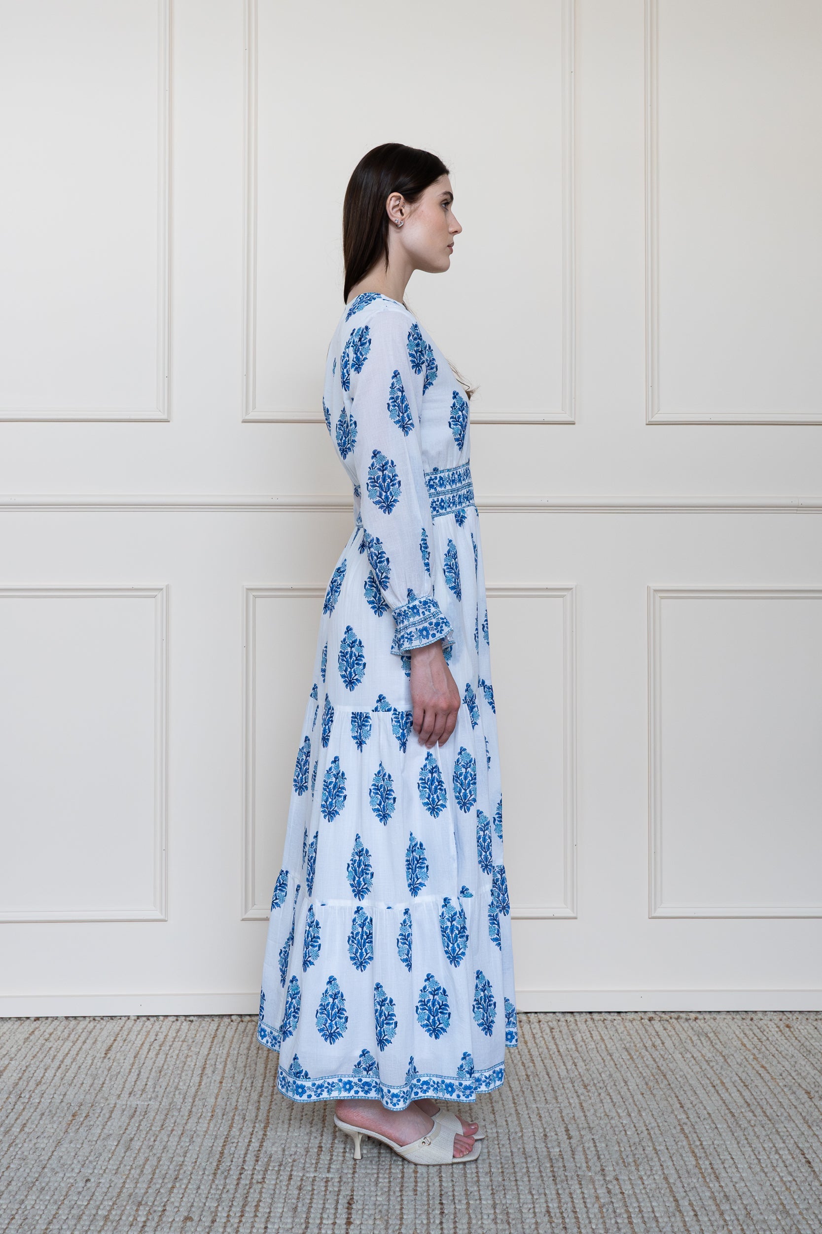 Side profile of Atherton Dress in blue showing full length sleeve and A-line silhouette.