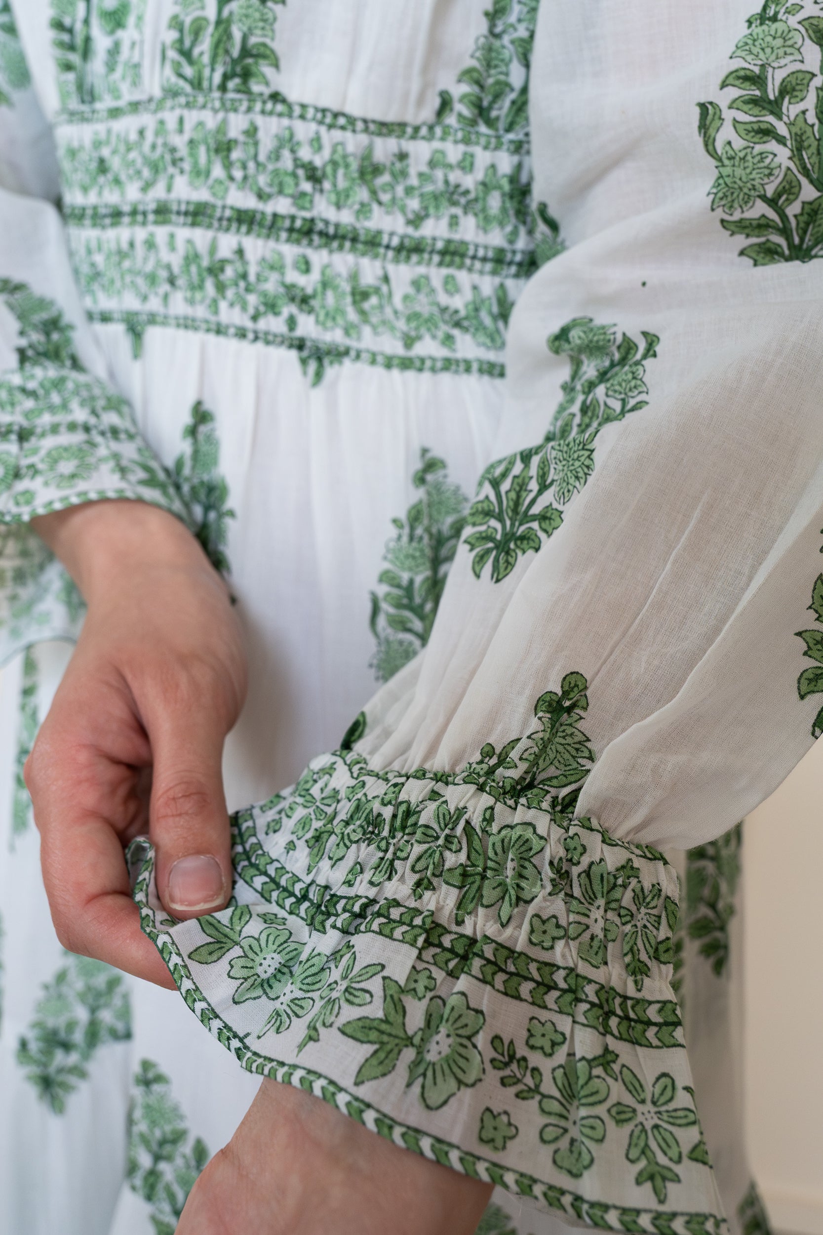 Close up of Atherton Dress sleeve showing ruffled cuff with sophisticated floral print and breathable soft organic cotton texture.