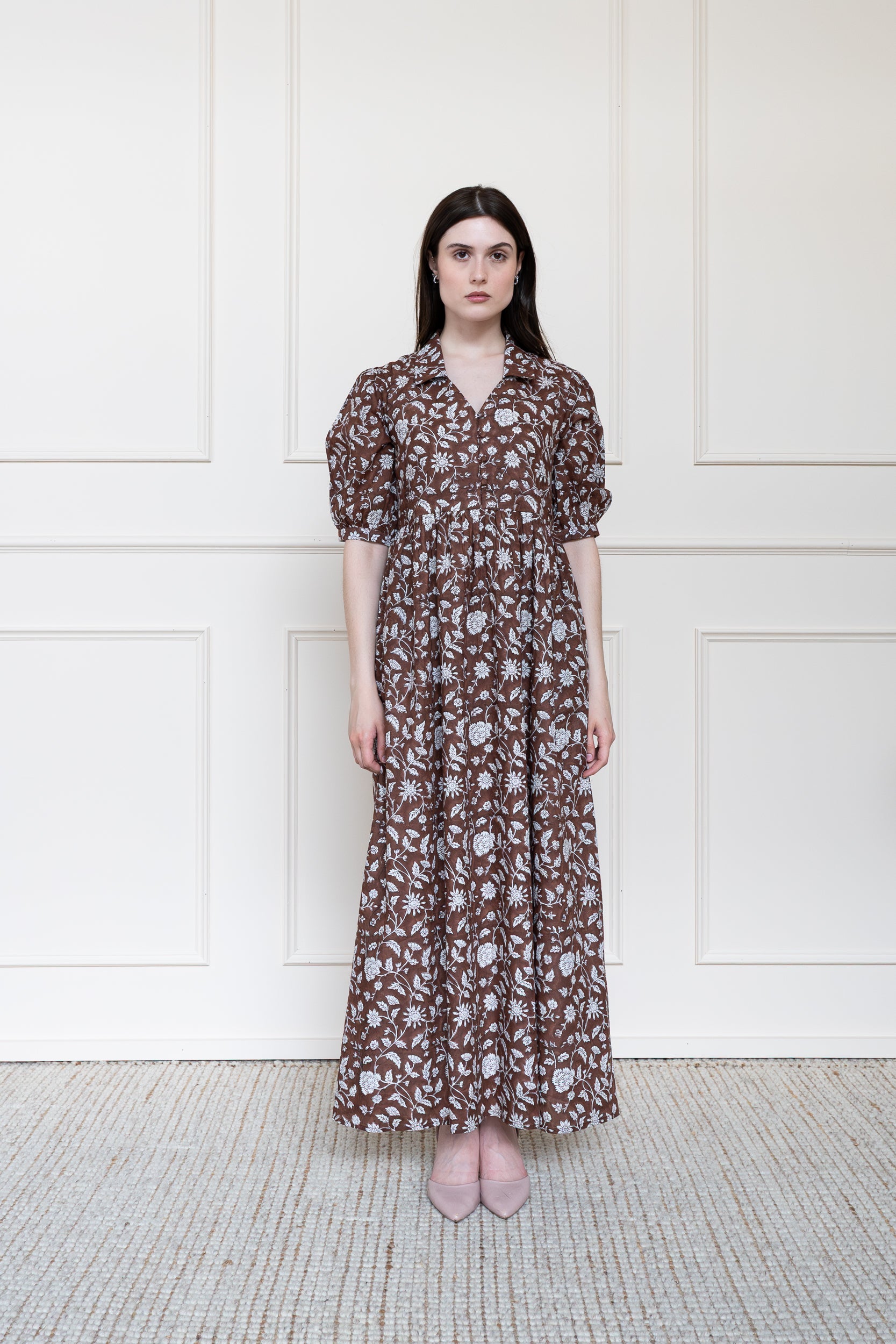 Full length front view of Balmoral Dress in brown floral print showing relaxed fit maxi length and button down front.