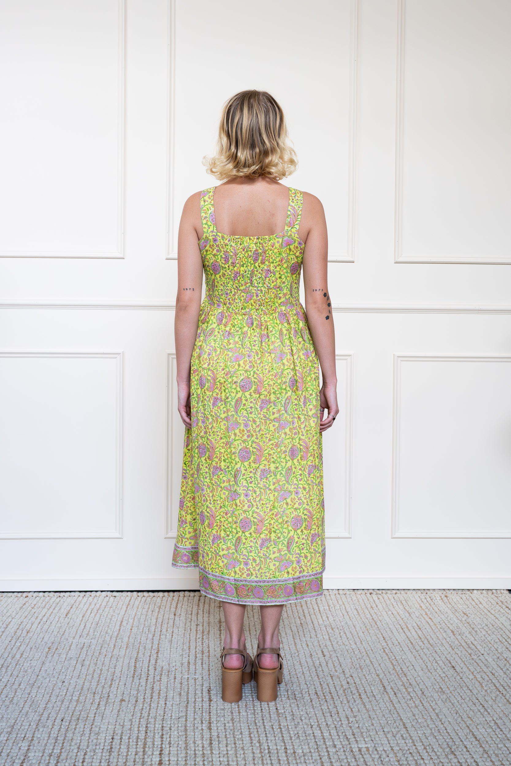 Back view of Cairns Dress in Lemon Myrtle showing flattering A-line silhouette, back smocking panel, and breathable cotton.