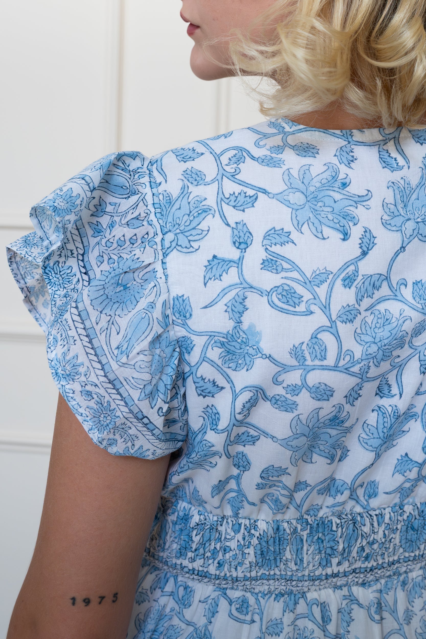 Close up back view of Daintree Dress showing sleeve design and authentic blue floral hand block print.