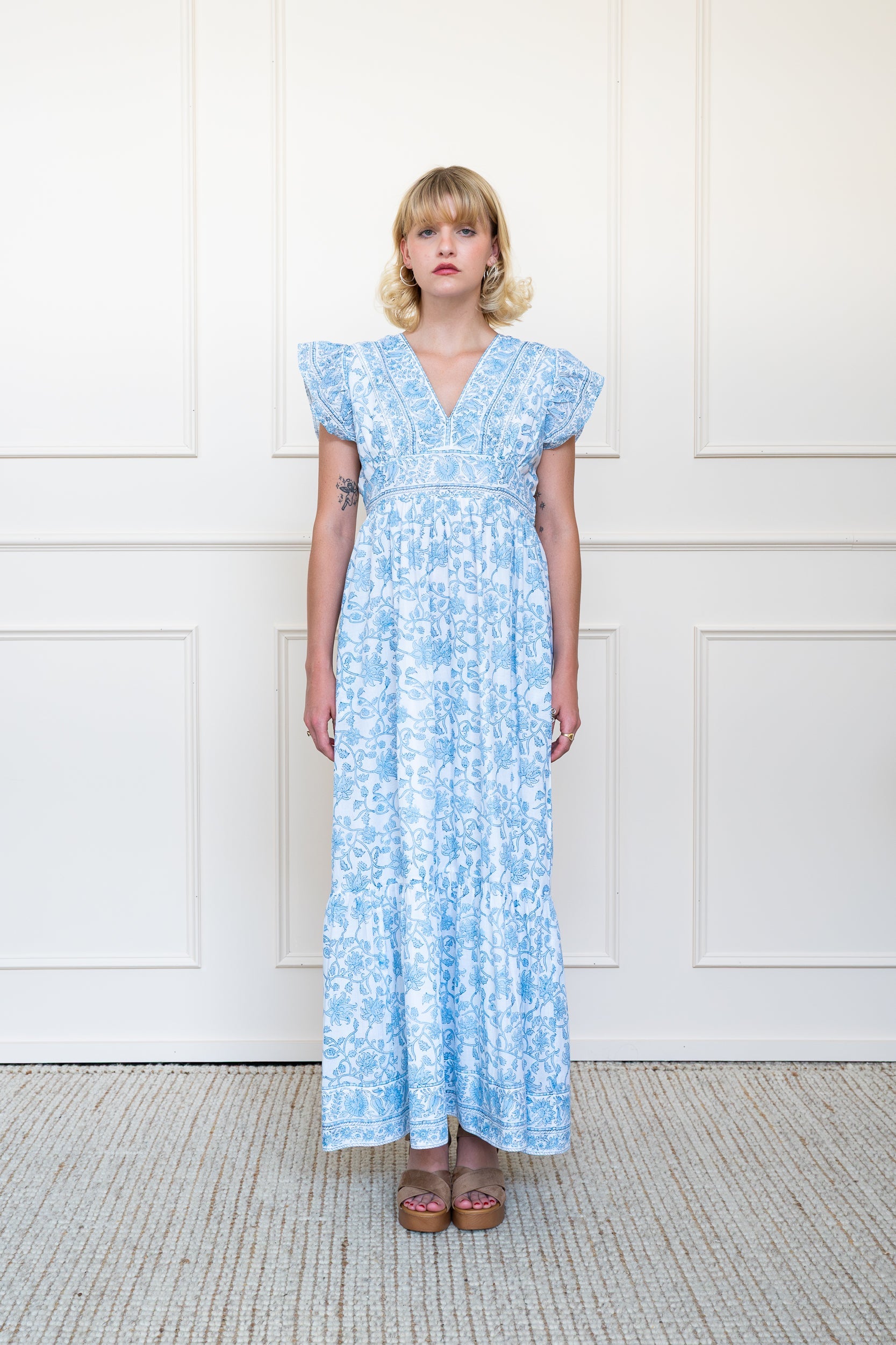 Full length front view of Daintree Dress in blue floral print showing relaxed fit maxi length and v-neckline.
