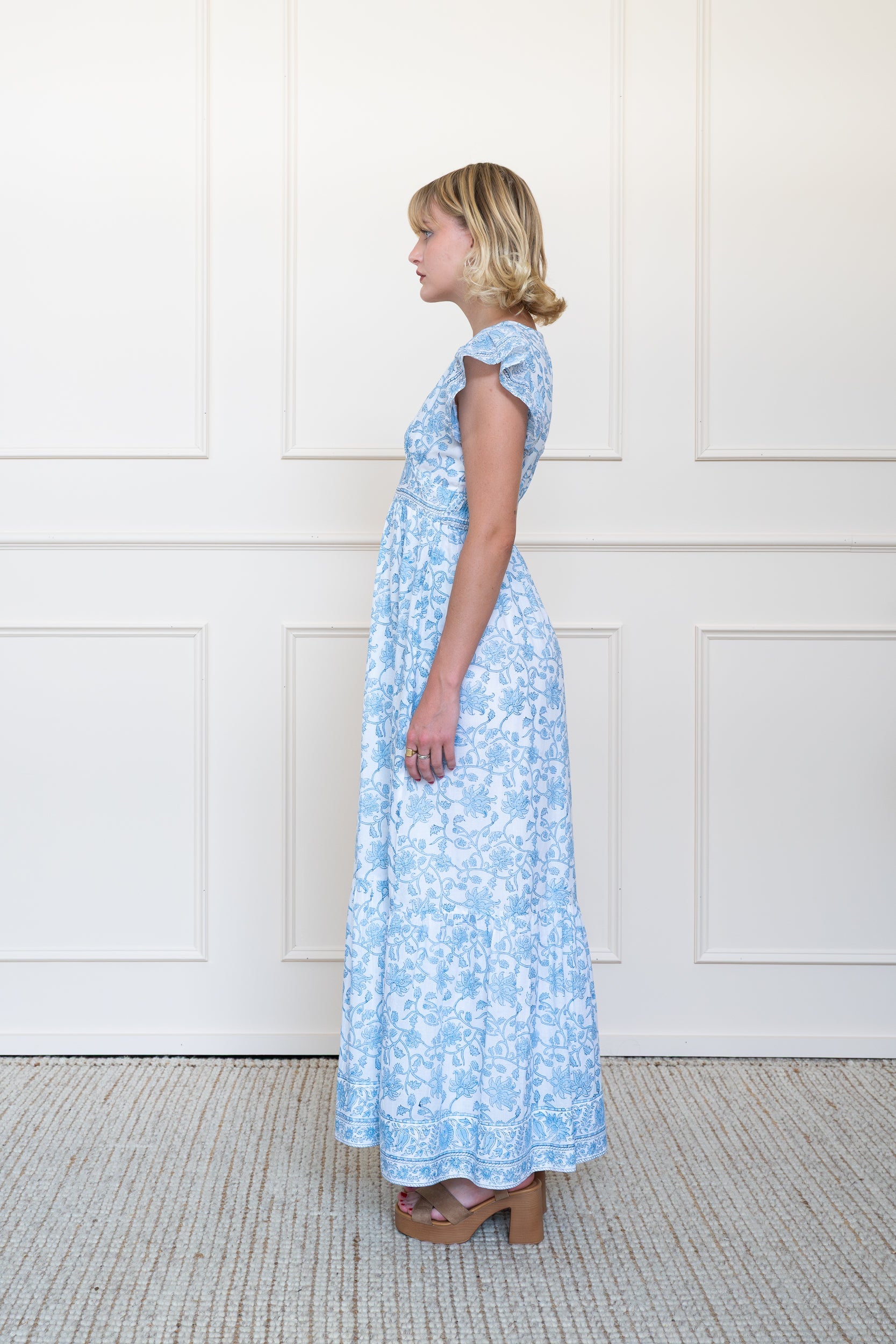 Profile view of Daintree Dress in Blue showing floral hand block print pattern and A-line skirt shape.