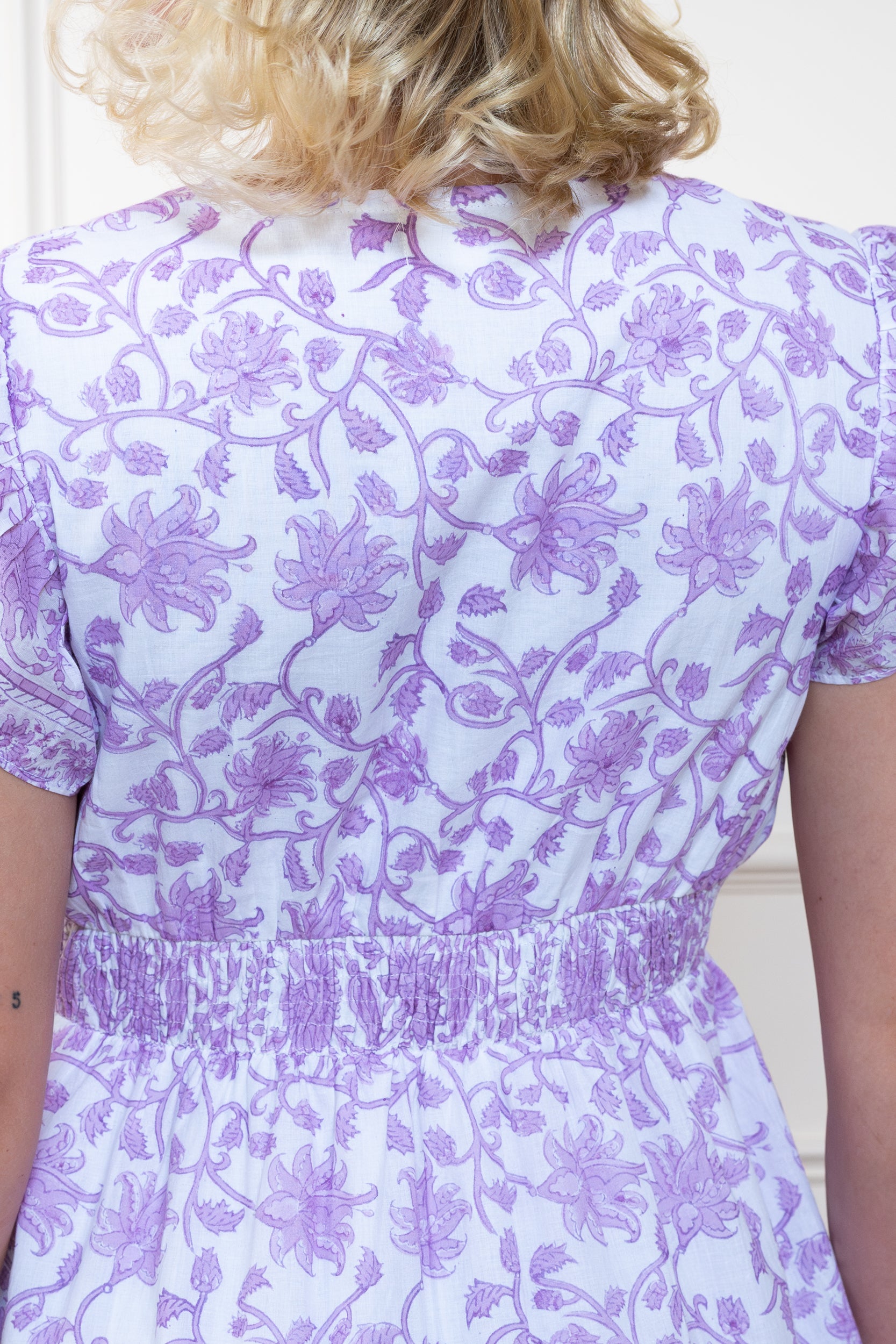 Close up back view of Daintree Dress showing authentic purple floral hand block print.