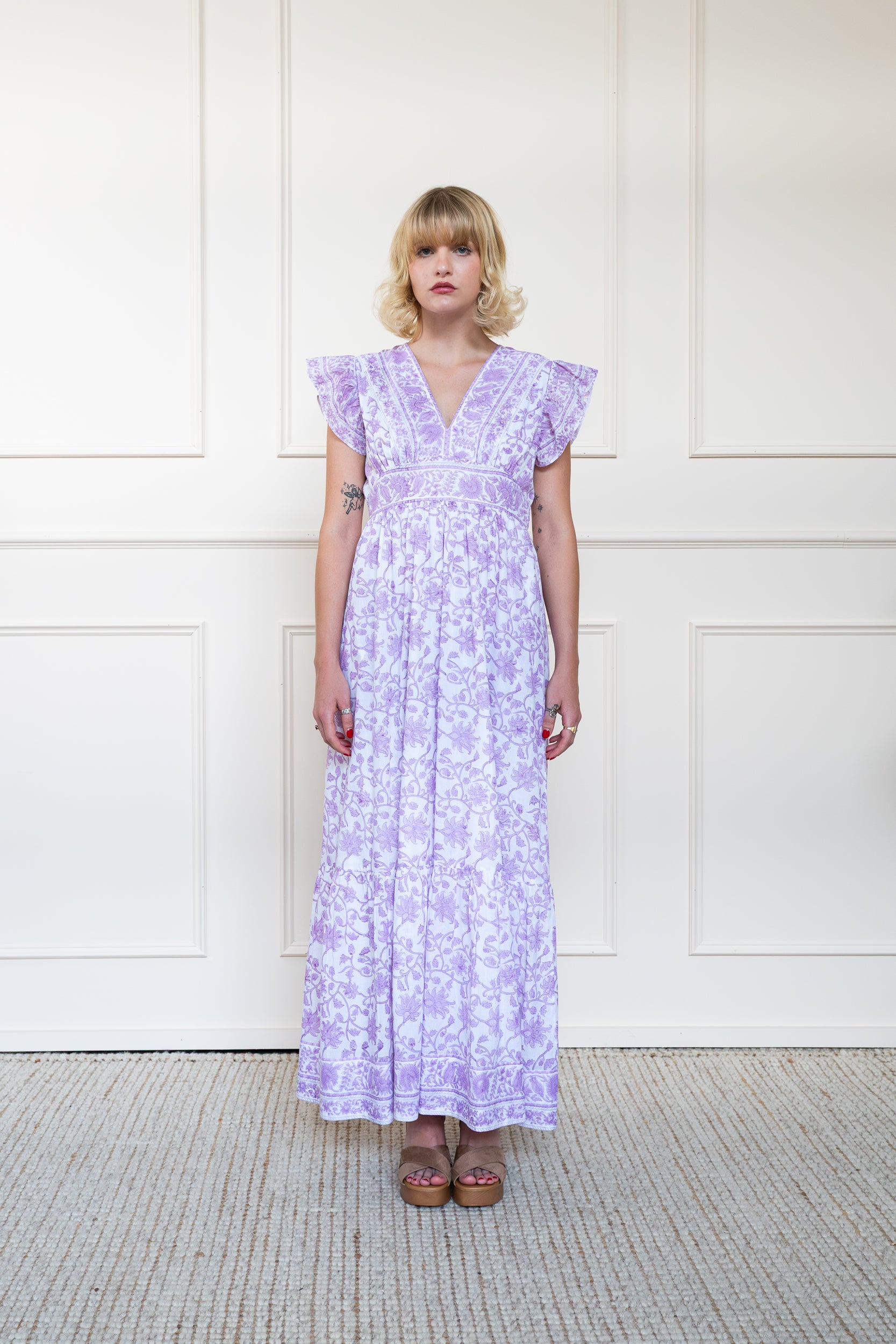 Full length front view of Daintree Dress in purple floral print showing relaxed fit maxi length and V-neckline.