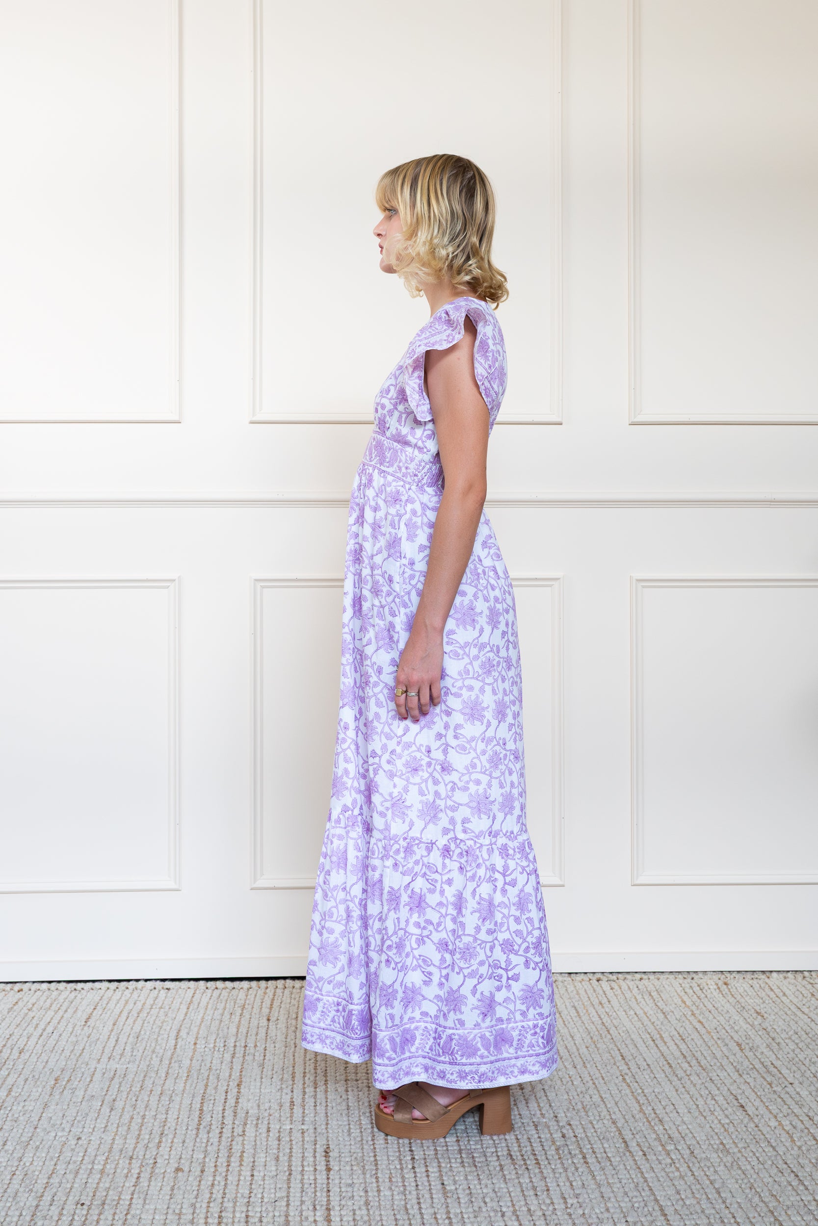 Profile view of Daintree Dress in Purple showing floral hand block print pattern and A-line skirt shape.