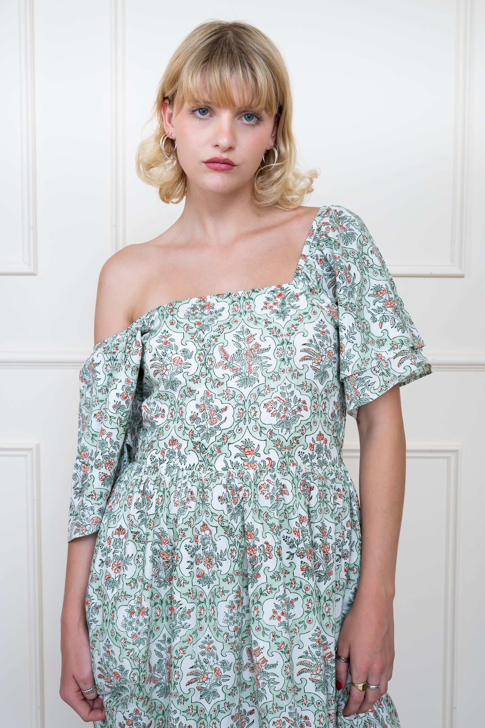 Grampians Dress in Sage Green showing adjustable sleeves worn lowered for versatile styling options.