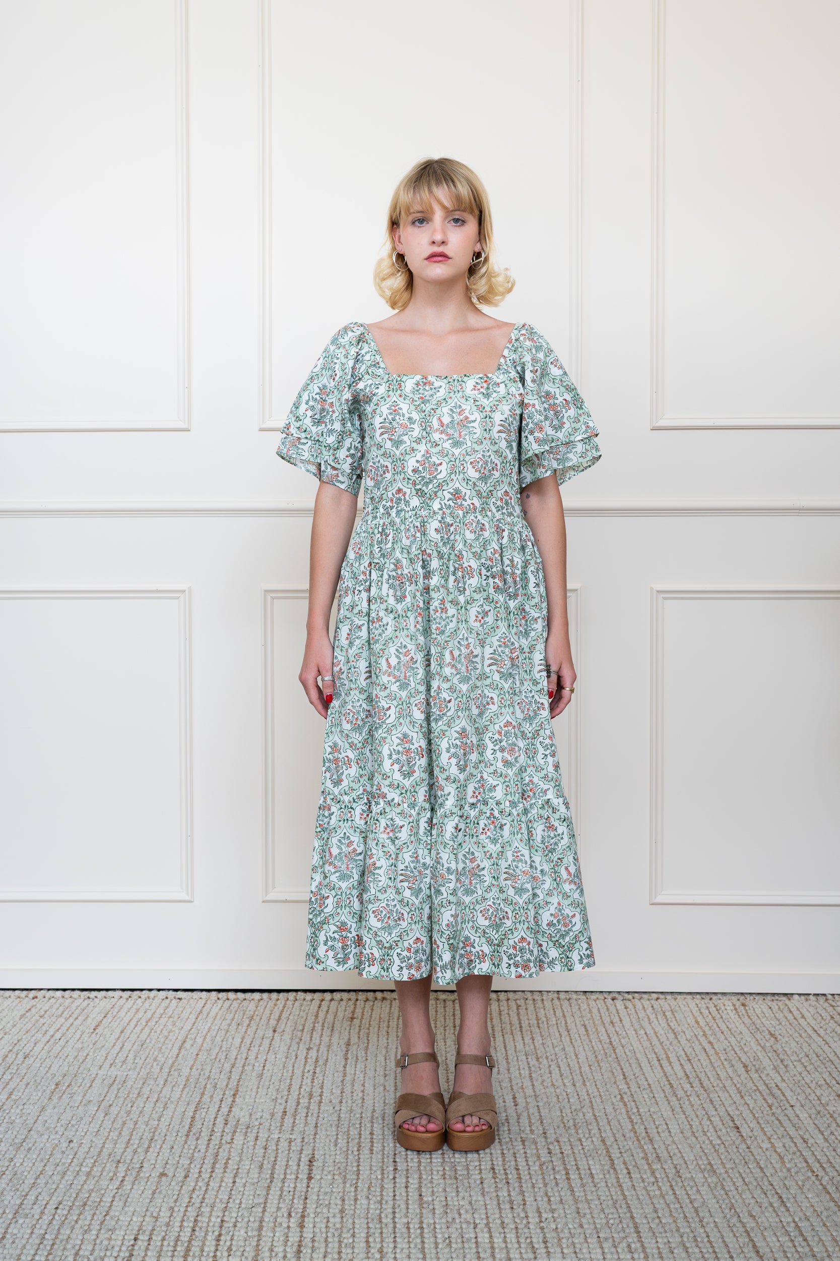 Full length front view of Grampians Dress in green floral print showing relaxed fit midi length and square neckline.