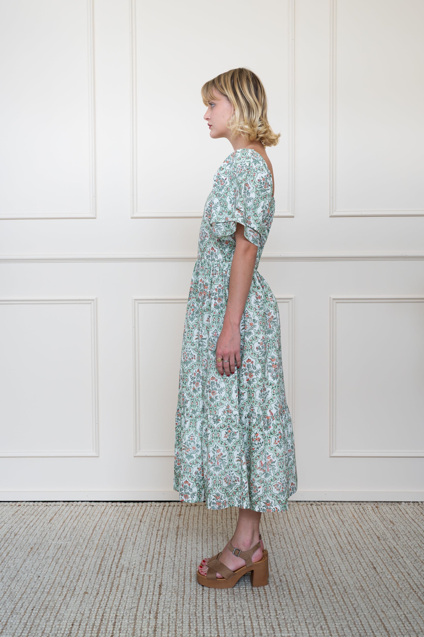 Profile view of Grampians Dress in Green showing floral hand block print pattern and A-line skirt shape.