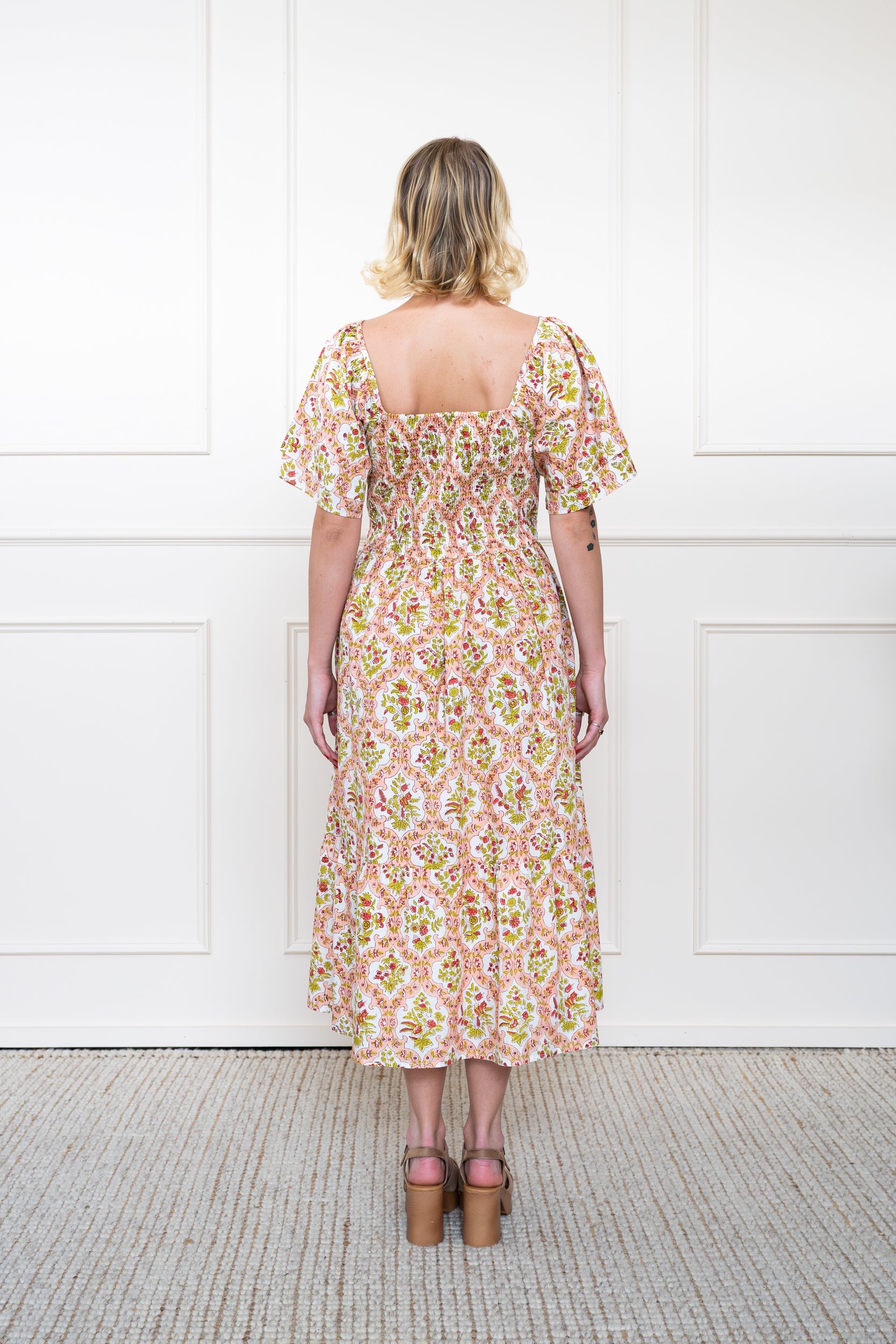 Back view of Grampians Dress in Peach Orange showing flattering A-line silhouette, back smocking panel, and breathable organic cotton.