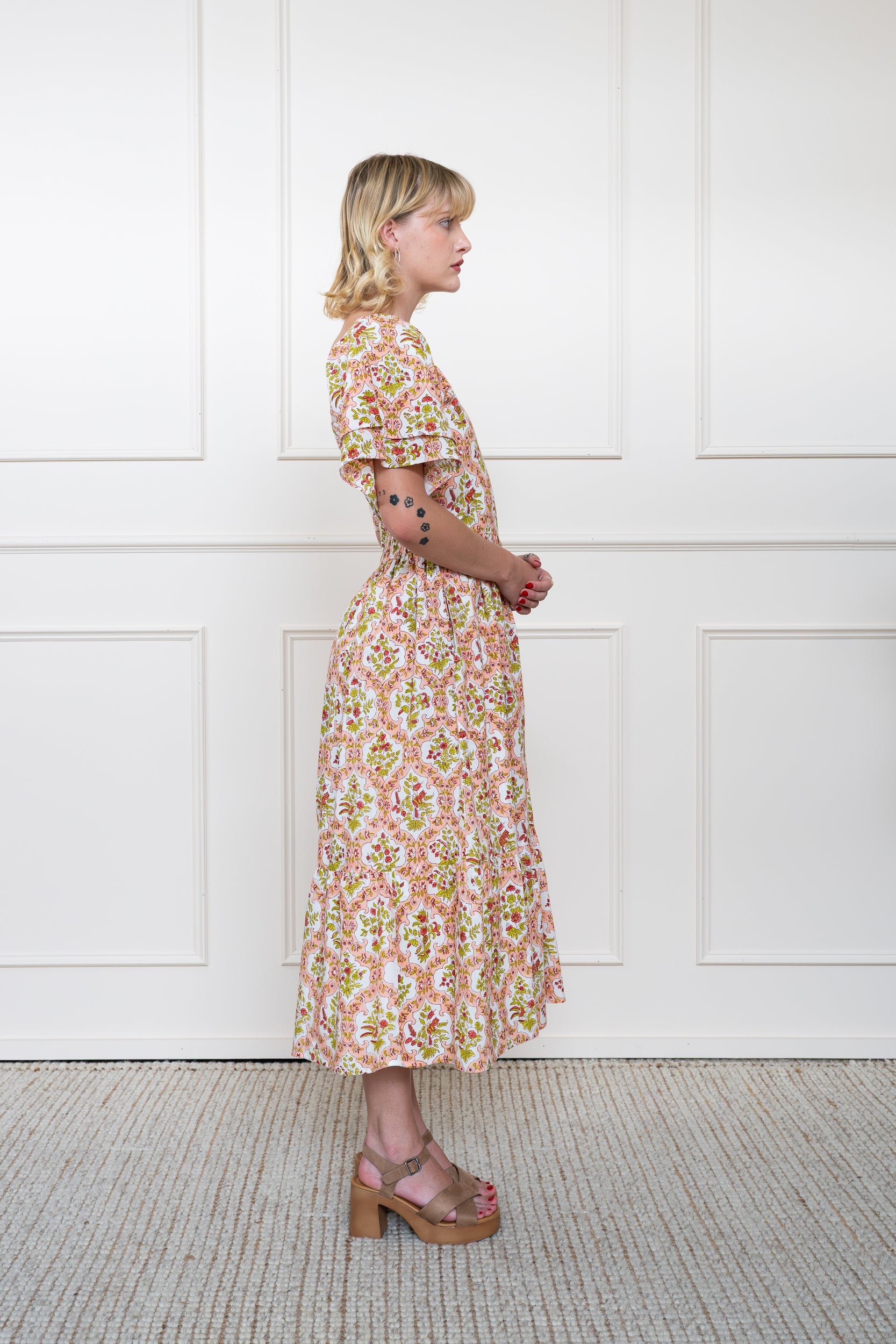 Side profile of Grampians Dress in Rose Garden showing versatile sleeve length and modest midi length fit.