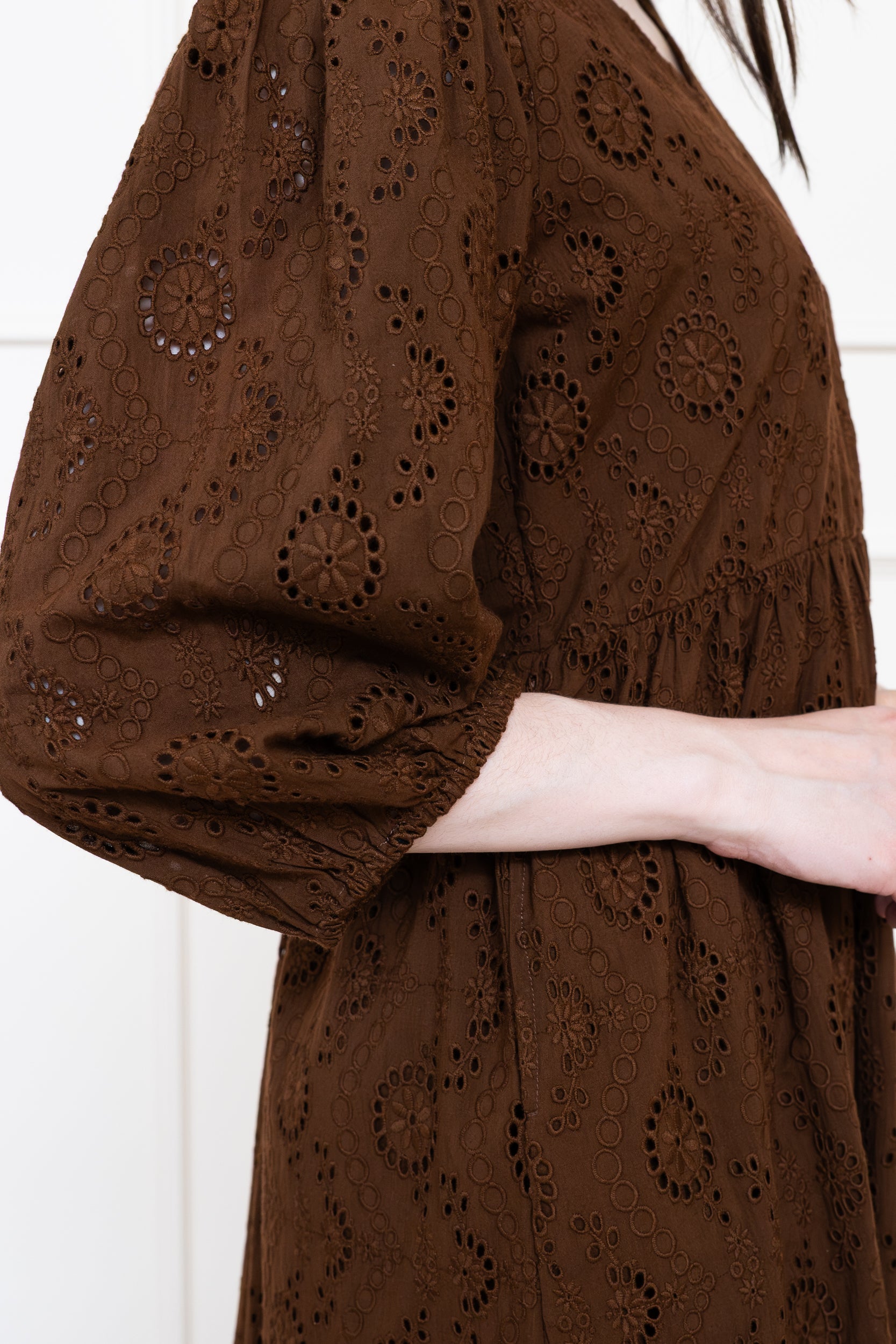 Close up of Tamarind Dress in Earth Rust showing relaxed fit 3/4 length sleeves and intricate schiffli embroidery.