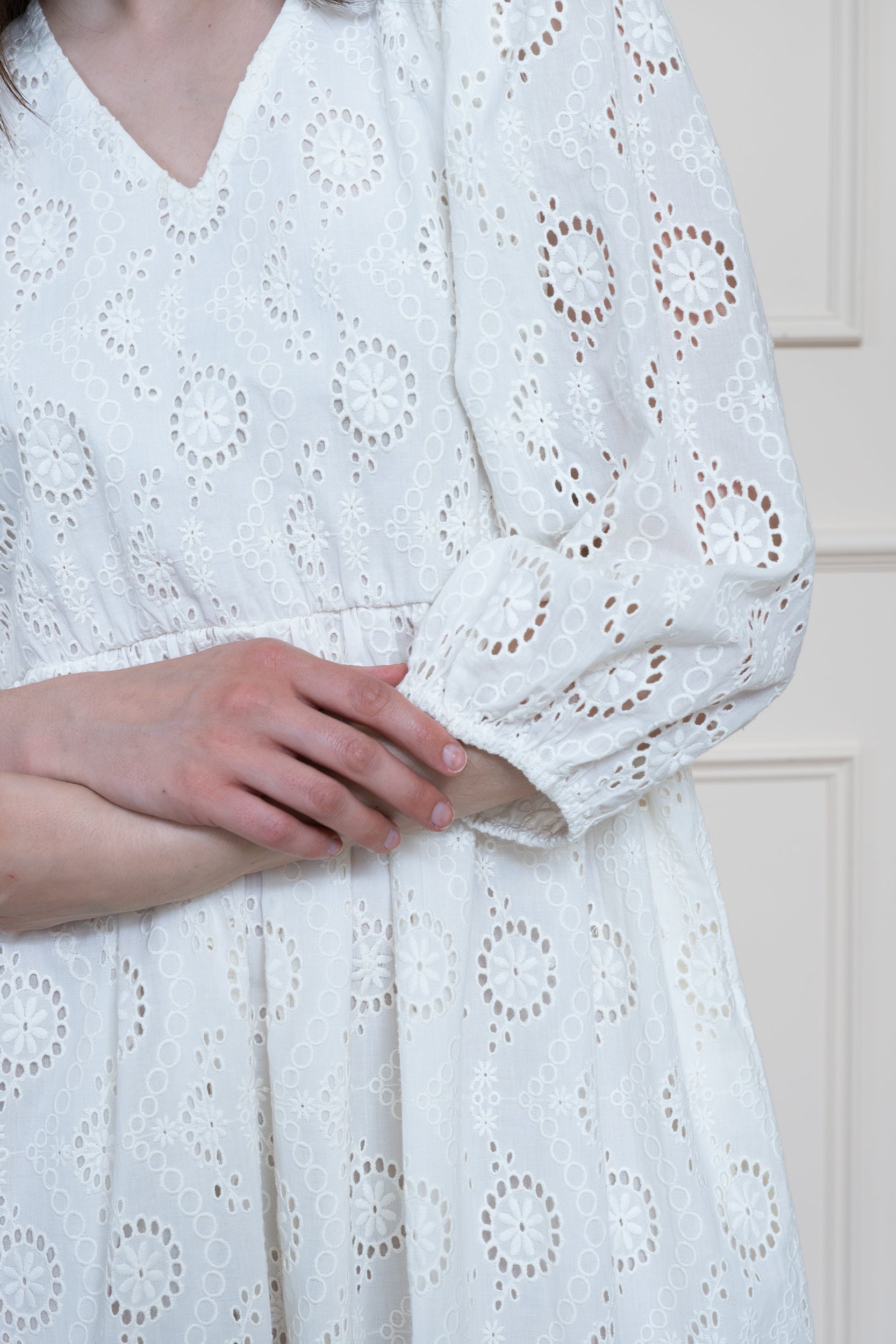 Texture detail of organic cotton fabric with Cotton Clouds white schiffli embroidery technique.