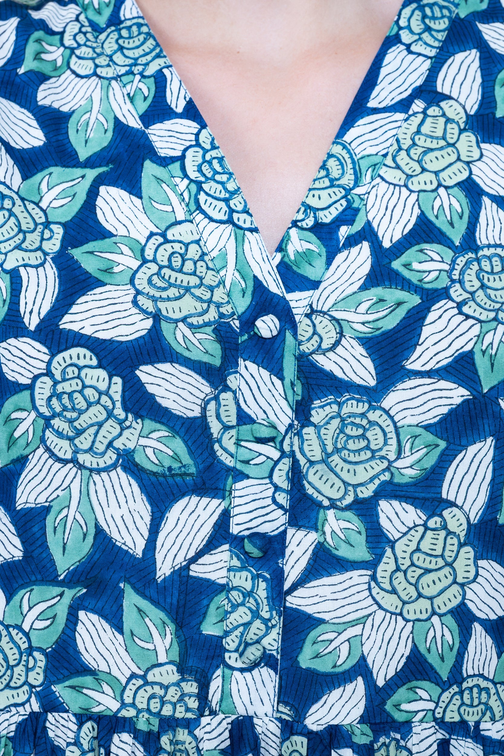 Close up front view of Yarra Valley Dress in Ocean Garden Blue showing neckline and floral print.