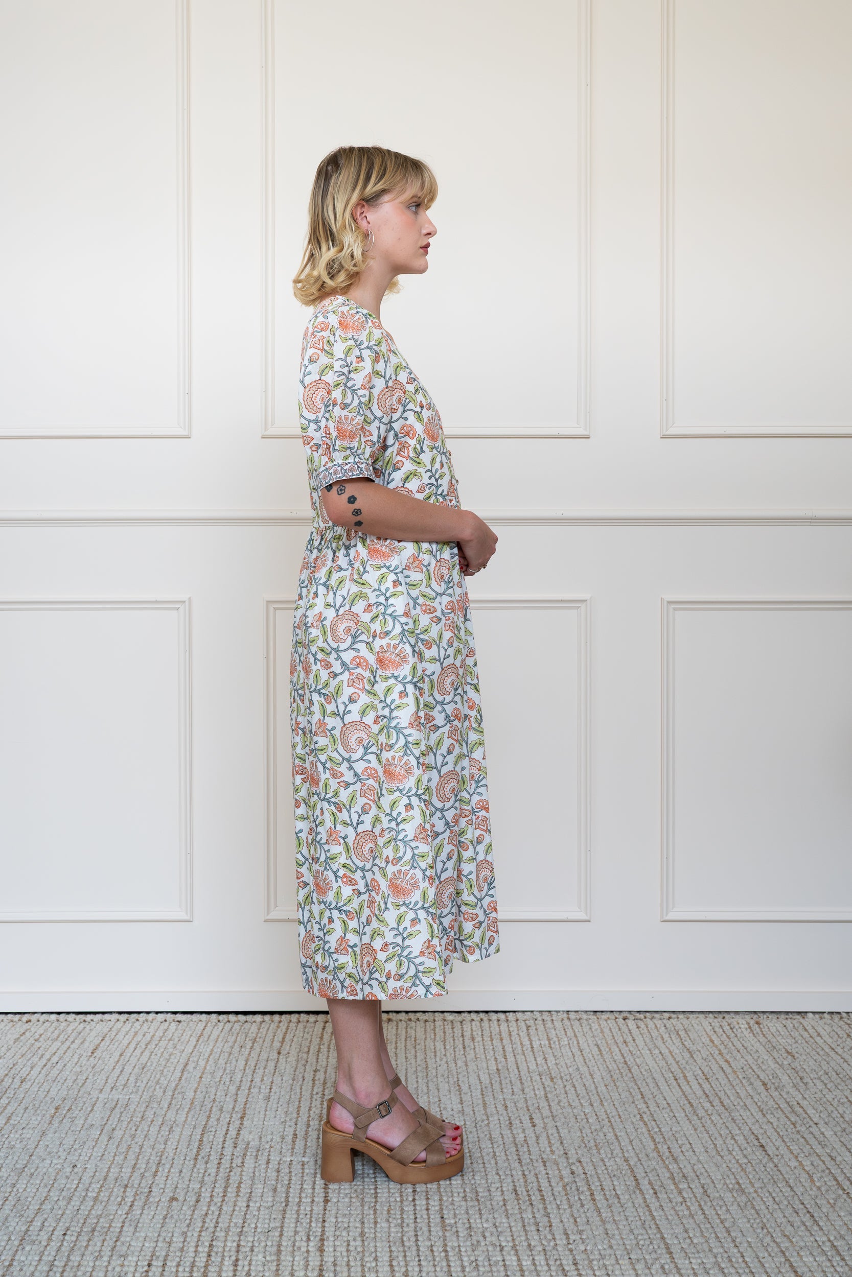 Side profile of Yarra Valley Dress showing elbow length sleeves and modest midi length fit.