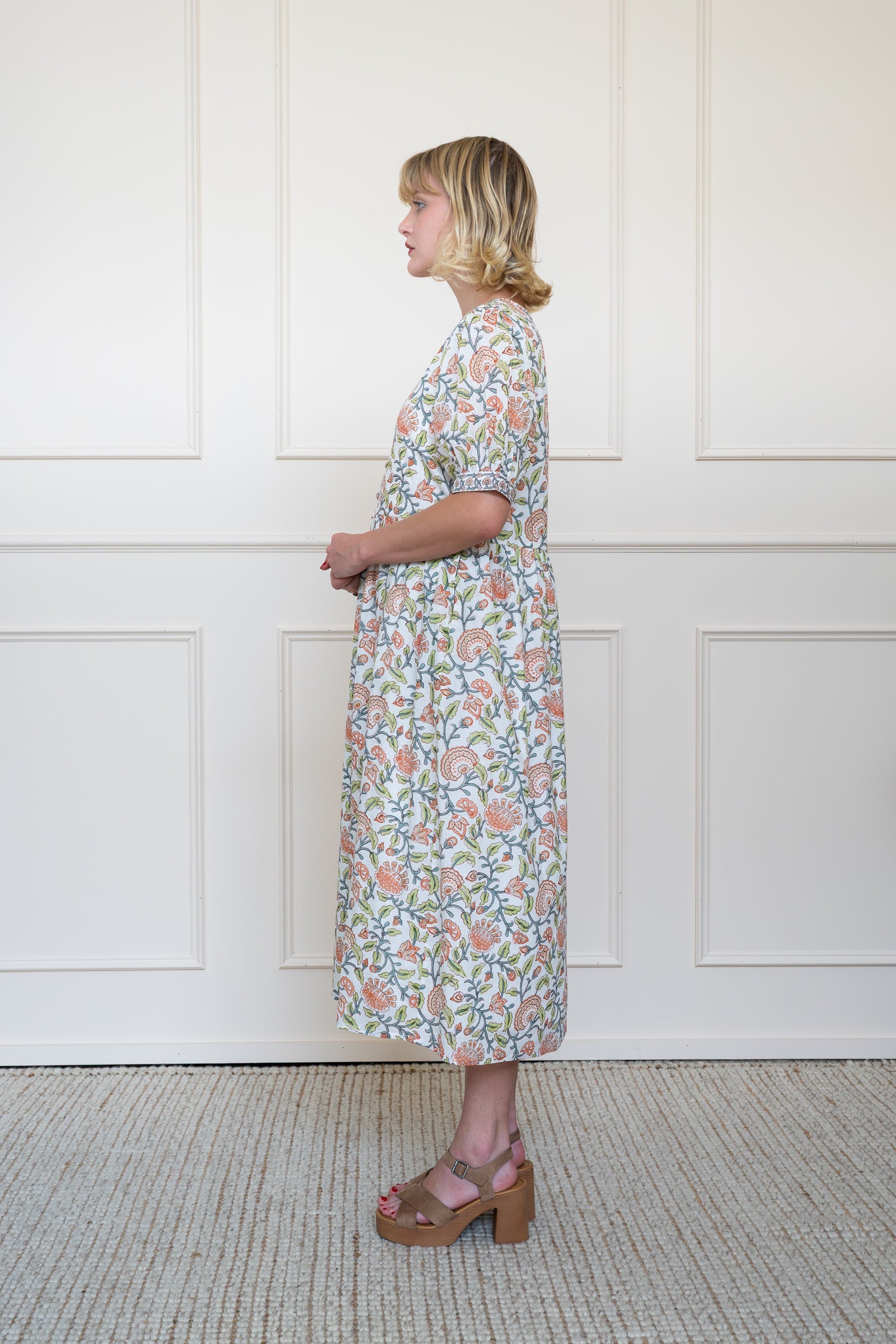 Side profile view of Yarra Valley Dress in Coral Garden showing relaxed summer silhouette and lightweight organic cotton drape.