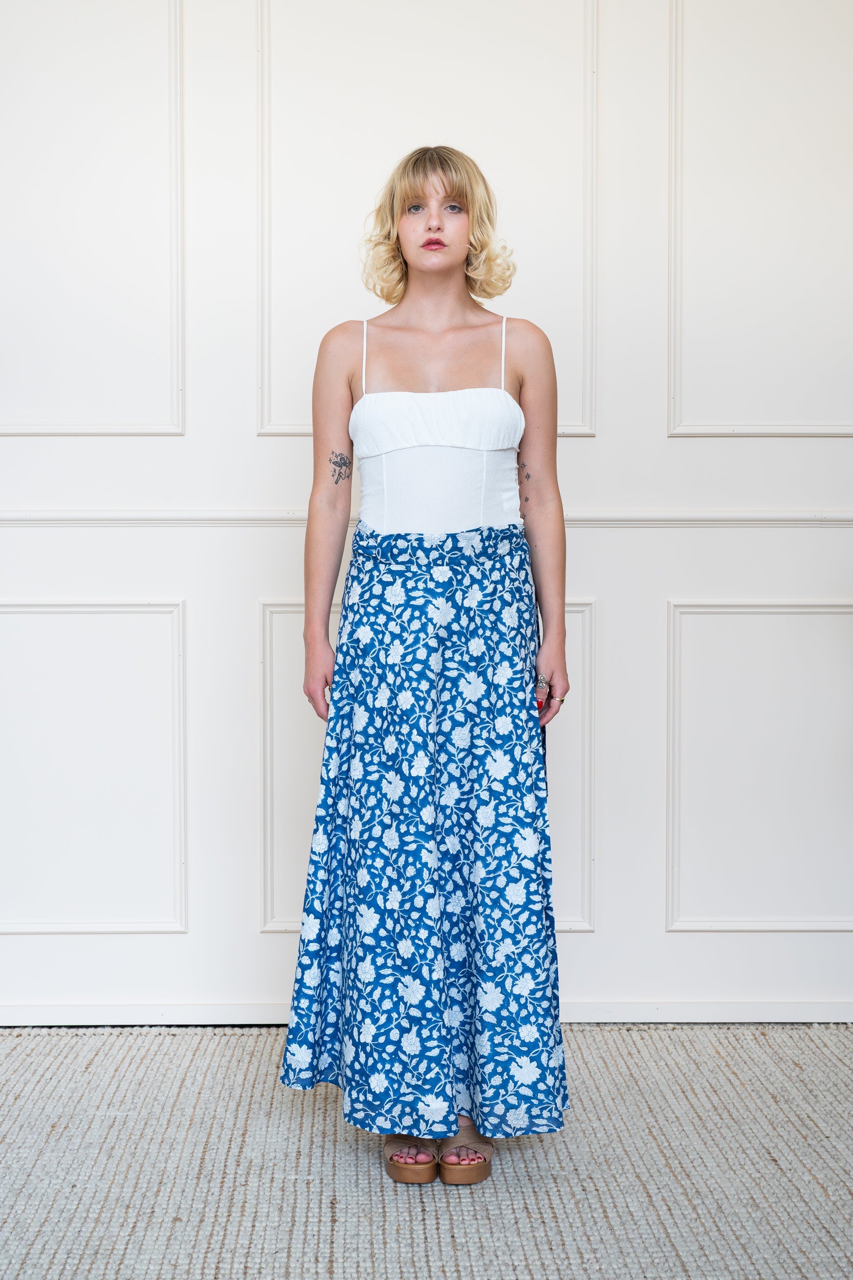 Full length front view of Flinders Skirt in Midnight Bloom Blue styled for summer work wear or resort holiday.